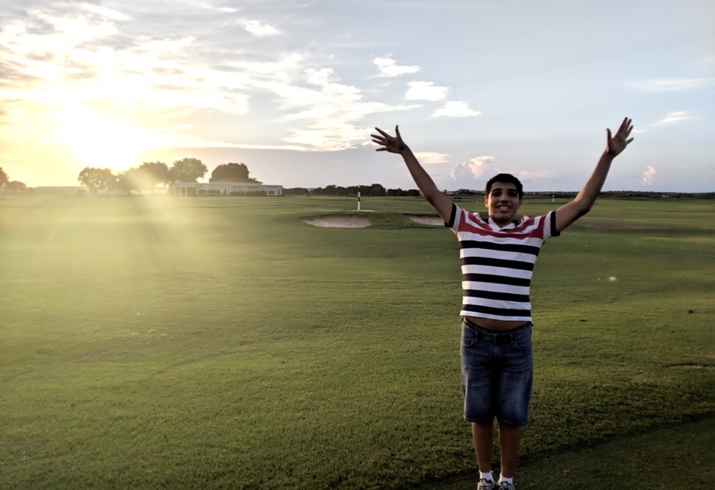 Marvin celebrating on a golf course at golden hour